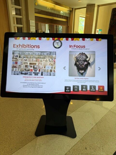 Capitol Art Collection screen on kiosk showing current exhibitions and featured artwork spotlight