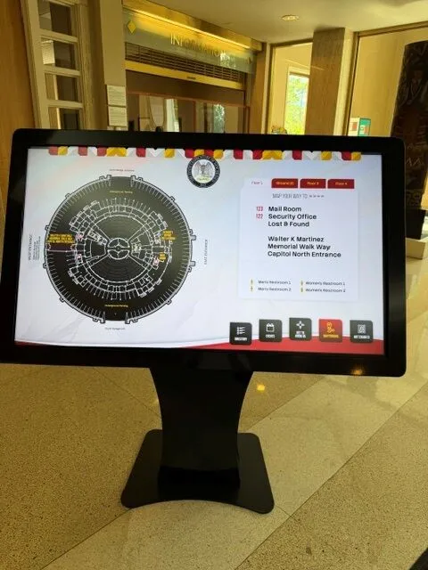 Interactive turn-by-turn wayfinding map on kiosk showing highlighted route across the Roundhouse