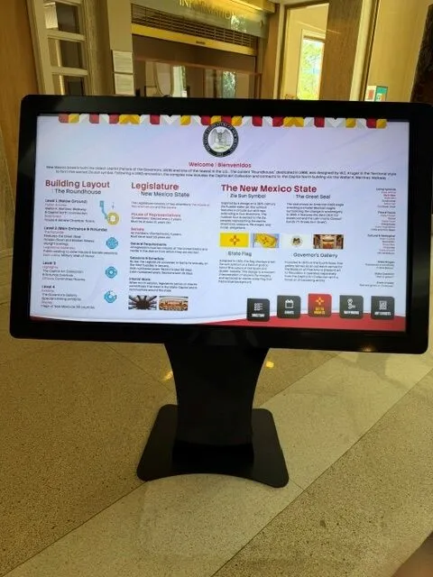 Building and state information screen on kiosk showing Roundhouse layout, legislature facts, and New Mexico state symbols