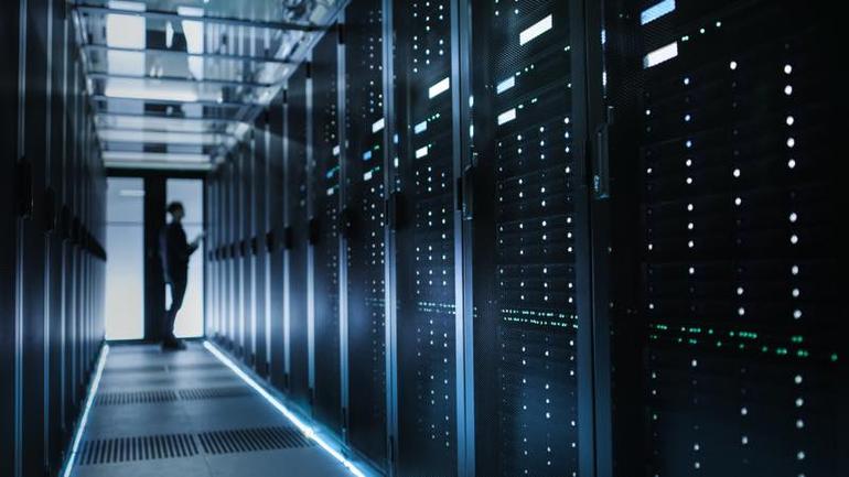 Photo of Out of Focus IT Technician Turning on Data Server 